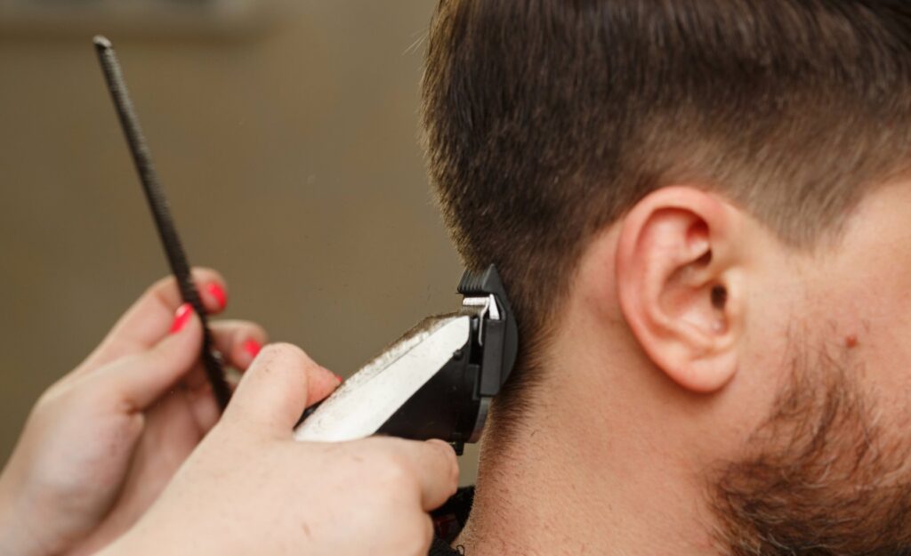 image depicting a young man being shaved for fue hair transplant