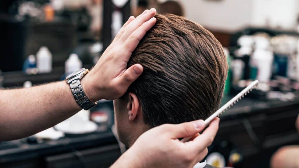 A man with a full head of hair, showing the results of his hair transplant